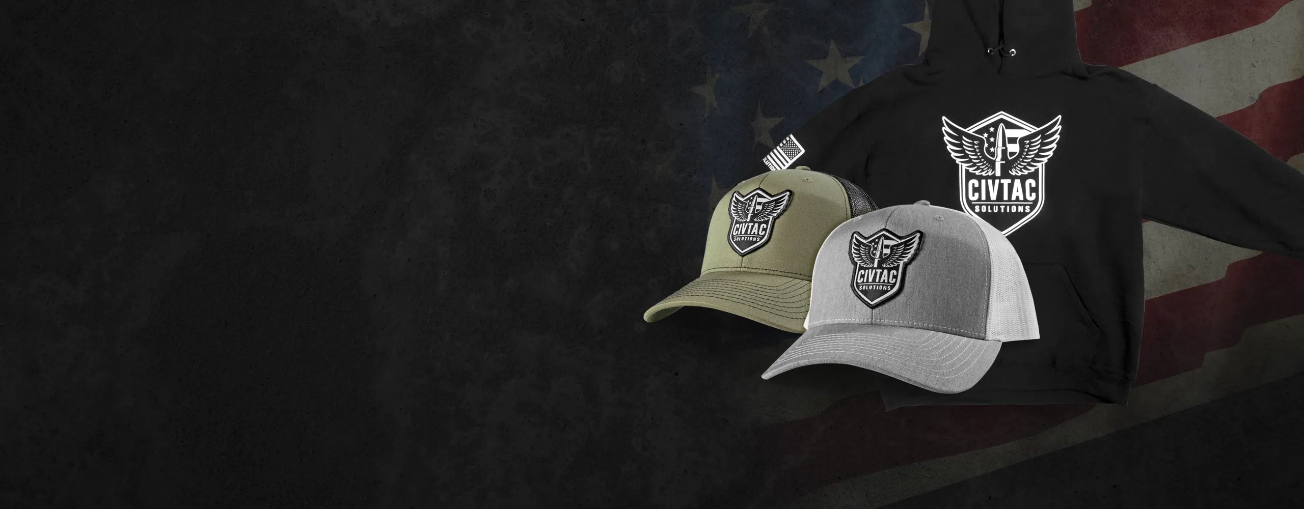 Two hats and a hoodie with a logo on a dark background